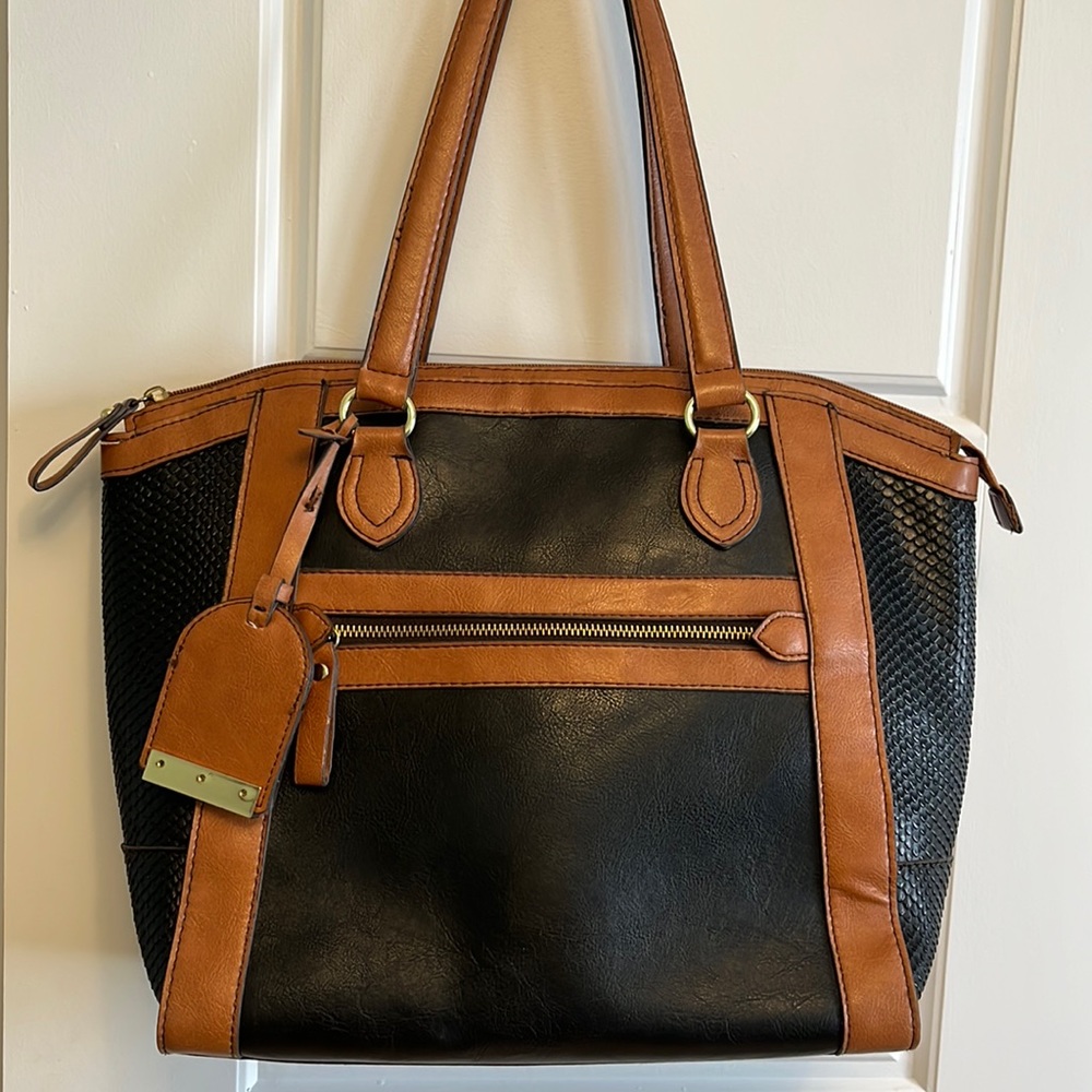 London Fog large black and tan simulated leather travel bag.